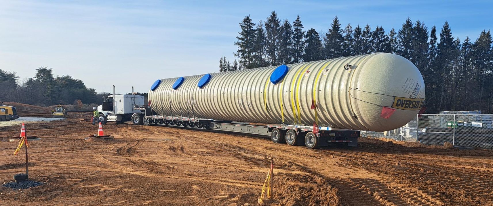 Fiberglass underground storage tank being delivered to a job site by Eastern States Associates